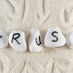 Trust word on group of stones on the sand